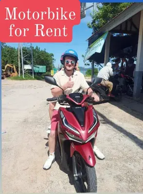 a woman is sitting on a motorcycle for rent at Farm House kohyaoyai in Ko Yao Yai