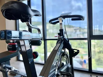 a bike parked next to a window with a helmet on it at The aristo-access pool room Surin beach in Phuket Town