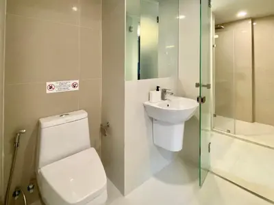 a bathroom with a toilet and a sink and a shower at The aristo-access pool room Surin beach in Phuket Town