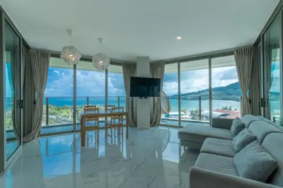 a living room with a couch and a table at Oceana Sea View - Kamala Beach in Kamala Beach