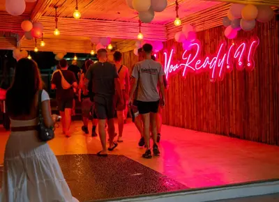 a group of people walking on a dance floor at Base Ao Nang Beachfront Party Hostel 18-35 Years Old Only in Ao Nang Beach