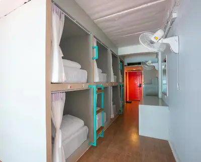 a room with four bunk beds and a hallway at Base Ao Nang Beachfront Party Hostel 18-35 Years Old Only in Ao Nang Beach