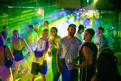 a group of people standing in a party at Base Ao Nang Beachfront Party Hostel 18-35 Years Old Only in Ao Nang Beach
