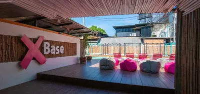 a group of pink bags sitting on a deck at Base Ao Nang Beachfront Party Hostel 18-35 Years Old Only in Ao Nang Beach