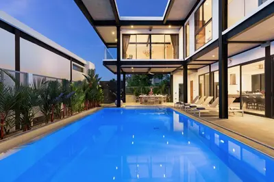 an image of a swimming pool in a house at Loft Style 4BR Villa Sunset Garden 4 with 12m Salt Water Pool, near NaiHarn in Rawai Beach