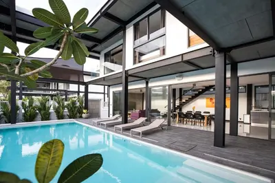 an external view of a house with a swimming pool at Loft-Style Hyper Modern 4Br Villa Sunset garden 6 with 12x5m Salt Pool in Rawai Beach