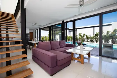 a living room with a purple couch and a table at Loft-Style Hyper Modern 4Br Villa Sunset garden 6 with 12x5m Salt Pool in Rawai Beach