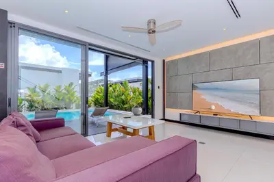 a living room with a purple couch and a tv at Loft-Style Hyper Modern 4Br Villa Sunset garden 6 with 12x5m Salt Pool in Rawai Beach