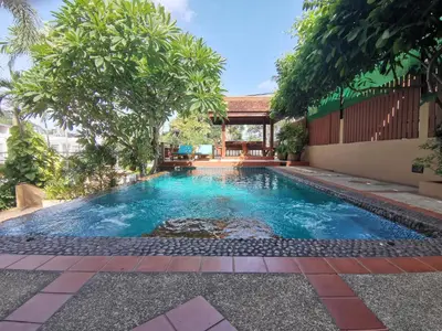 a swimming pool in a yard with trees at Kata Pool Villa ​No.7 in Kata Beach