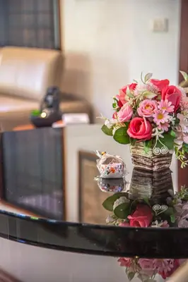 a vase with a bouquet of flowers on a table at Kata Pool Villa ​No.7 in Kata Beach