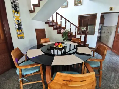 a dining room with a black table and chairs at Kata Pool Villa ​No.7 in Kata Beach