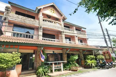 a large building with a balcony on top of it at Casa Brazil Homestay in Karon Beach
