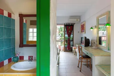 a bathroom with a tub and a kitchen with a table at Casa Brazil Homestay in Karon Beach