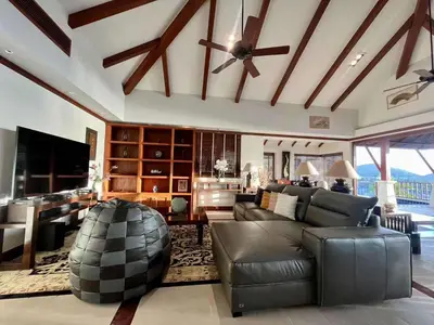 a living room with a couch and a ceiling fan at Patong Seaview Luxury Villa Penda in Patong Beach