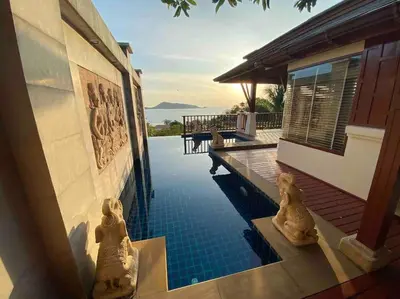 a house with a swimming pool next to a house at Patong Seaview Luxury Villa Penda in Patong Beach