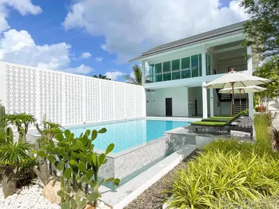 a swimming pool in front of a villa at The Pin Boutique Pool Villa Krabi in Ao Nang Beach