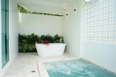 a bath tub in a bathroom with a bath tub at The Pin Boutique Pool Villa Krabi in Ao Nang Beach
