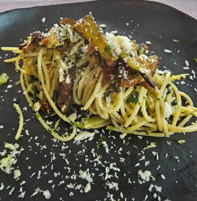 a plate of pasta on a black plate at The Pin Boutique Pool Villa Krabi in Ao Nang Beach