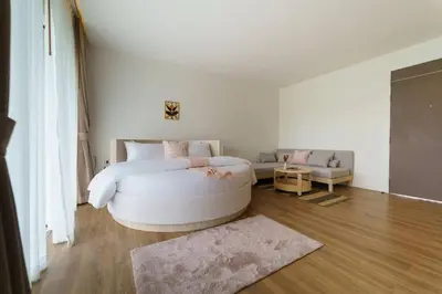 a bedroom with a large white bed and a couch at The Pin Boutique Pool Villa Krabi in Ao Nang Beach