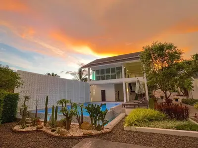 a large house with a swimming pool in front of it at The Pin Boutique Pool Villa Krabi in Ao Nang Beach