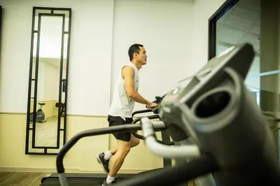 a man walking on a treadmill in a gym at Holiday Style Ao Nang Beach Resort, Krabi in Ao Nang Beach