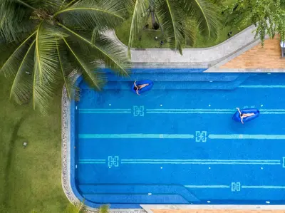 an overhead view of a swimming pool with blue water at Holiday Style Ao Nang Beach Resort, Krabi in Ao Nang Beach