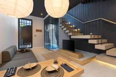 a living room with a couch and a table at Villoft Zen Living Resort in Thalang