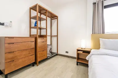 a bedroom with a bed and a wooden dresser at Kamala Fantasy 5 Bedroom Modern Private Pool Villa in Kamala Beach