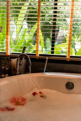 a kitchen sink with flowers in the water at Touch Beachfront Pool Villa Koh Yao Noi in Ko Yao Noi