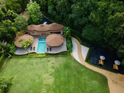 an aerial view of a house with a swimming pool at Touch Beachfront Pool Villa Koh Yao Noi in Ko Yao Noi