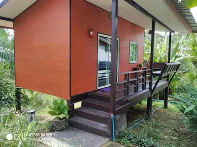 a tiny house with a large wooden deck at Lok Mun Bungalows in Ko Yao Noi