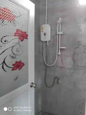 a shower stall in a bathroom with a toilet at Lok Mun Bungalows in Ko Yao Noi