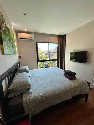 a bedroom with a large bed and a large window at The Title Rawai Beach West Wing by EHM in Rawai Beach