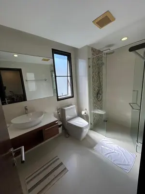 a bathroom with a sink and a toilet and a shower at The Title Rawai Beach West Wing by EHM in Rawai Beach