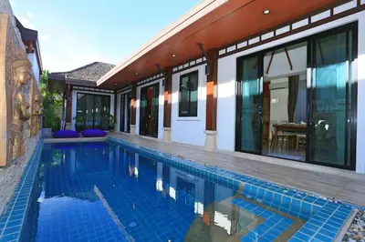 a swimming pool in front of a house at 3bedroom pool villa only 250m to the Rawai beach F10 in Phuket Town