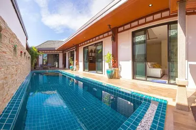 a swimming pool in front of a house at 3bedroom pool villa only 250m to the Rawai beach F10 in Phuket Town