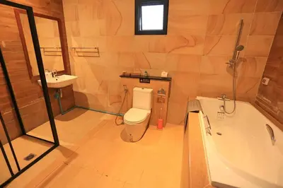 a bathroom with a toilet and a bath tub at 3bedroom pool villa only 250m to the Rawai beach F10 in Phuket Town