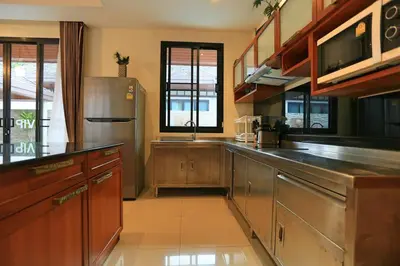 a large kitchen with a stainless steel refrigerator at 3bedroom pool villa only 250m to the Rawai beach F10 in Phuket Town