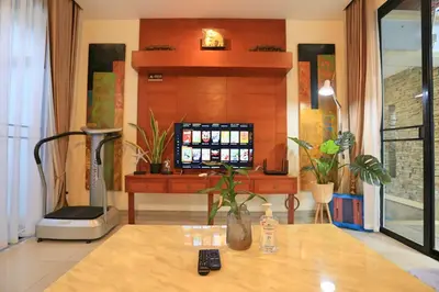 a living room with a television and a table at 3bedroom pool villa only 250m to the Rawai beach F10 in Phuket Town