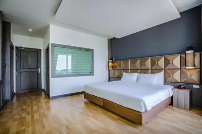 a bedroom with a large bed and a window at Add Plus Hotel & SPA in Patong Beach
