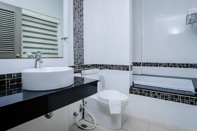 a bathroom with a white toilet and a sink at Add Plus Hotel & SPA in Patong Beach