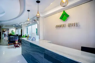 a restaurant with a counter with a green sign on the wall at Add Plus Hotel & SPA in Patong Beach