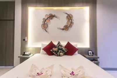 a bedroom with a bed with two crab decorations on the wall at Nut & Non Pool Villa by Duangtham in Ban Khlong Haeng