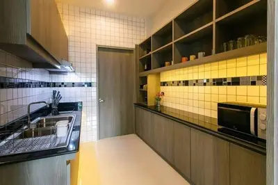 a kitchen with a sink and a microwave at Nut & Non Pool Villa by Duangtham in Ban Khlong Haeng