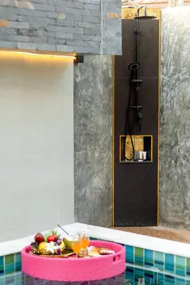 a bath tub with a plate of fruit on top of it at Nut & Non Pool Villa by Duangtham in Ban Khlong Haeng