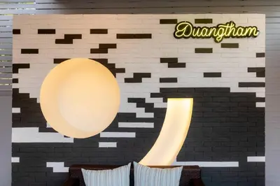 a restaurant with a wall with a giant mirror at Nut & Non Pool Villa by Duangtham in Ban Khlong Haeng