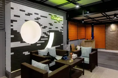 a lobby with couches and a sign on a brick wall at Nut & Non Pool Villa by Duangtham in Ban Khlong Haeng