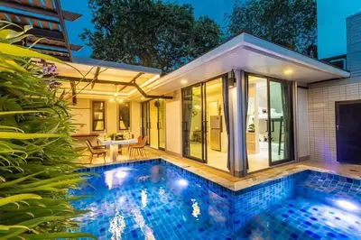 a swimming pool in front of a house at Nut & Non Pool Villa by Duangtham in Ban Khlong Haeng