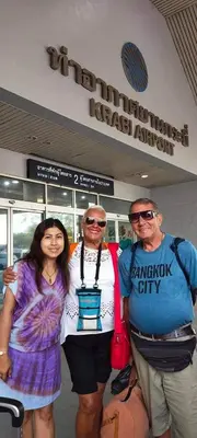 a group of three people standing in front of an airport at Life&Love Resort in Ban Khlong Son