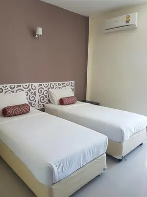 two beds in a room with white walls at Life&Love Resort in Ban Khlong Son